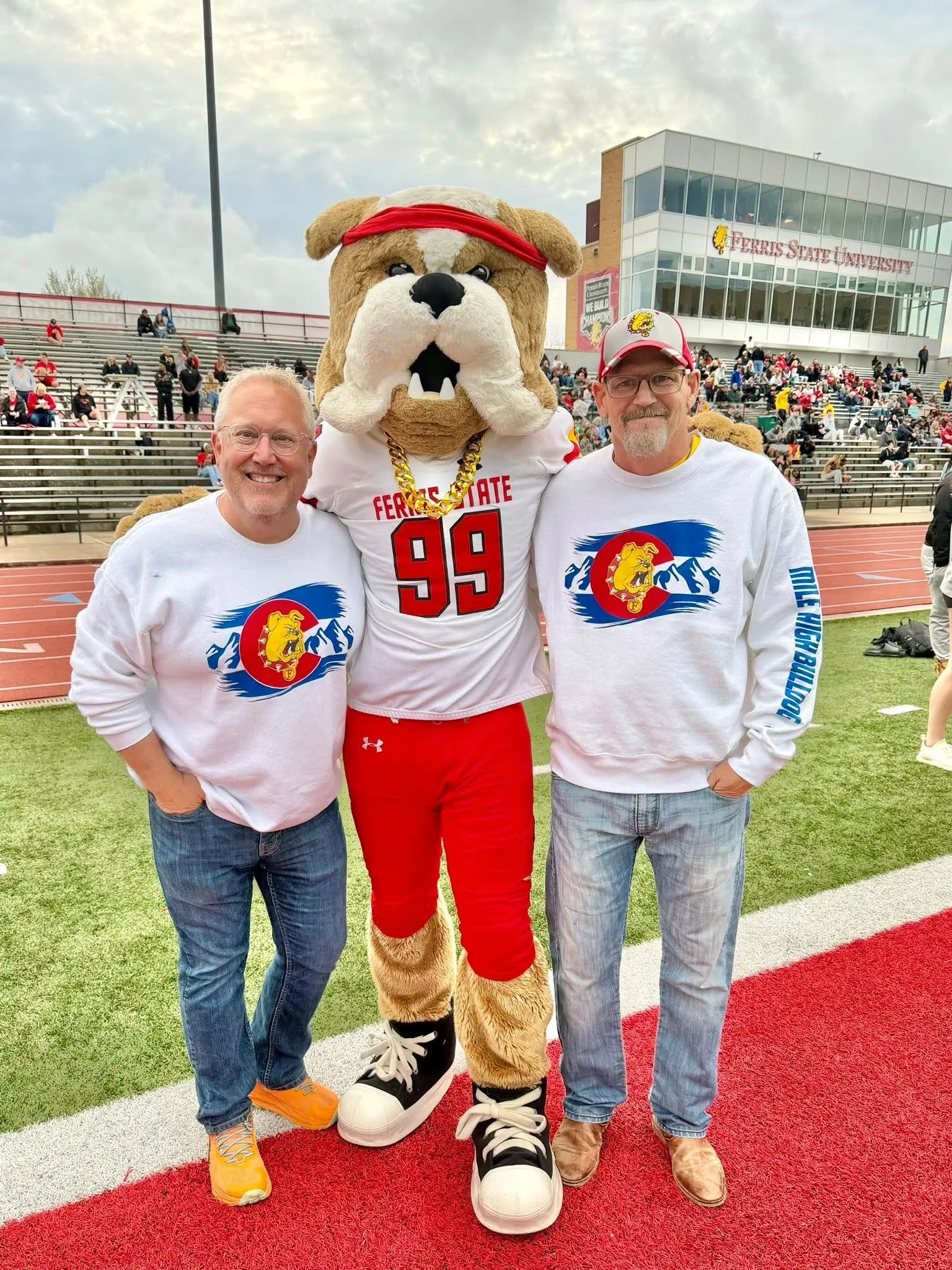 Ferris State alumni with the bulldog mascot at a Ferris State game