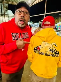 Two supporters showing Mile High Bulldogs apparel at a gathering